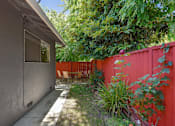 Thumbnail 18 of 36 - A red fence and a grey wall with a window.