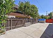 Thumbnail 16 of 36 - A backyard with a fence, a tree, and a shed.