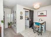 Thumbnail 39 of 41 - a dining room with a table and a door to a kitchen
