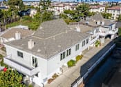 Thumbnail 30 of 41 - an aerial view of a house with a roof and a body of water