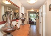 Thumbnail 35 of 41 - a view of a hallway with vases on a glass table