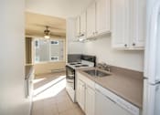 Thumbnail 25 of 41 - a kitchen with white cabinets and a sink