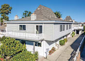 Thumbnail 34 of 41 - a white house with a gray roof and a sidewalk