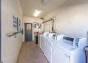 Thumbnail 21 of 32 - a laundry room with washes and dryers in it