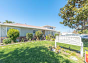 Thumbnail 7 of 32 - a house with a lawn and a sign in front of it