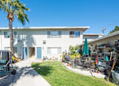Thumbnail 11 of 32 - a white house with a palm tree in front of it