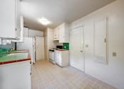 Thumbnail 13 of 25 - a kitchen with white cabinets and a stove and a refrigerator