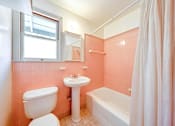 Thumbnail 12 of 25 - a bathroom with a sink toilet and a bath tub