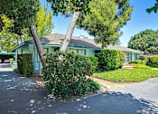 Thumbnail 1 of 25 - a green house with a tree in front of it