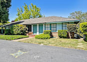 Thumbnail 10 of 25 - a blue house with green shutters and a sidewalk