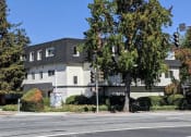 Thumbnail 2 of 15 - an apartment building on the corner of a street