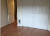 Thumbnail 10 of 15 - an empty living room with wood floors and a door