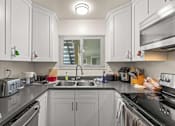 Thumbnail 3 of 43 - a kitchen with white cabinets and a sink