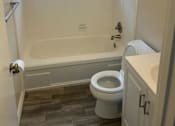 Thumbnail 13 of 13 - A white bathroom with a toilet, sink, and bathtub.