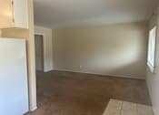 Thumbnail 8 of 13 - A room with a white door and a brown carpet.