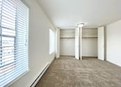 Thumbnail 10 of 51 - a bedroom with a large window and a closet
