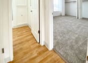 Thumbnail 11 of 51 - an empty room with white walls and wood floors