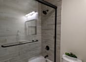 Thumbnail 10 of 11 - a small bathroom with a toilet and a shower