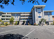 Thumbnail 2 of 11 - an apartment building with a clock tower in front of it