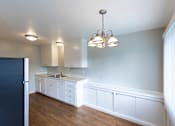 Thumbnail 26 of 30 - a kitchen with white cabinets and a counter top and a refrigerator