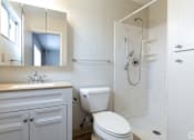Thumbnail 21 of 30 - a bathroom with a toilet and a sink and a shower