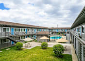Thumbnail 16 of 30 - a view of a courtyard with tables and umbrellas