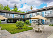 Thumbnail 14 of 30 - a courtyard with tables and chairs and umbrellas