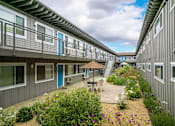 Thumbnail 9 of 30 - the courtyard is full of flowers and tables and chairs