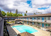 Thumbnail 8 of 30 - a view of a pool and a building with a swimming pool