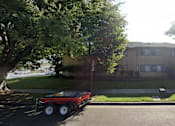 Thumbnail 25 of 26 - A red truck is parked on the street in front of a house.