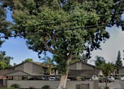 Thumbnail 14 of 17 - A street view of a residential area with houses on both sides.