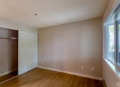 Thumbnail 14 of 20 - an empty bedroom with a closet and a window