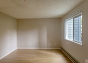Thumbnail 15 of 20 - an empty room with wooden floors and a large window