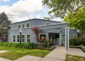 Thumbnail 4 of 20 - the front of a blue house with a sidewalk and grass