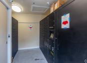 Thumbnail 10 of 20 - a room with black lockers and a hallway with a door