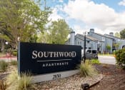 Thumbnail 2 of 20 - a sign for southwood apartments in front of some houses