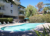 Thumbnail 5 of 22 - a swimming pool in front of an apartment building