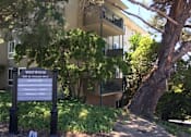 Thumbnail 1 of 8 - an apartment building with a sign in front of it
