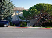 Thumbnail 4 of 8 - a car parked in front of a building