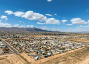 Thumbnail 2 of 4 - A small town with a mountain in the background.