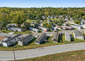 Thumbnail 13 of 15 - A road runs through a residential area with houses on both sides.