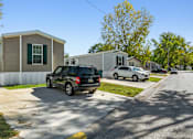 Thumbnail 1 of 15 - A black SUV is parked in front of a house.