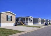 Thumbnail 2 of 6 - A line of houses with a clear blue sky above them.