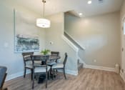 Thumbnail 6 of 10 - A dining room with a table and chairs at Ventura Townhouses, Michigan, 49460