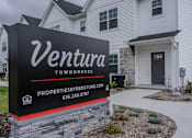 Thumbnail 5 of 11 - A sign for Ventura Townhouses with a website and phone number.