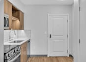 Thumbnail 52 of 109 - Kitchen with white door at Altaire at Jackson Park, Seattle