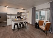 Thumbnail 35 of 41 - A modern kitchen with a refrigerator , stove, and bar stools