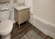 Thumbnail 39 of 41 - A white toilet sites next to a sink in a bathroom