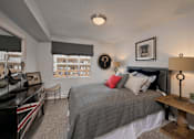 Thumbnail 34 of 41 - A bedroom with a bed, a desk, and a chair