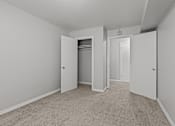Thumbnail 26 of 41 - A room with carpeted floors and three doors.